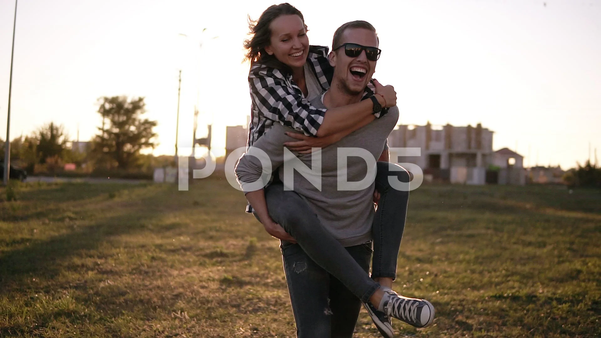Young Man Giving Woman Piggyback Outdoors, Stock image