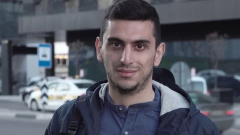 Happy young middle eastern man on city street Stock Footage 88773339