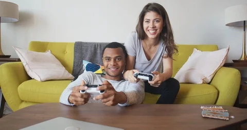 Chinese Girlfriend And Boyfriend Playing Videogame Using Games Console  Sitting On Floor At Home. Computer Gaming And Videogames For Couple, Family  Weekend Leisure Concept Stock Photo, Picture and Royalty Free Image. Image