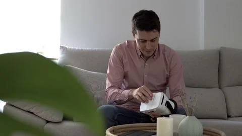 Happy young millennial man using virtual reality at home - VR headset technology Stock Footage 145773015