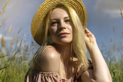 Happy young model in hat, concept of freedom and rest in summer. Summer field Stock Photos