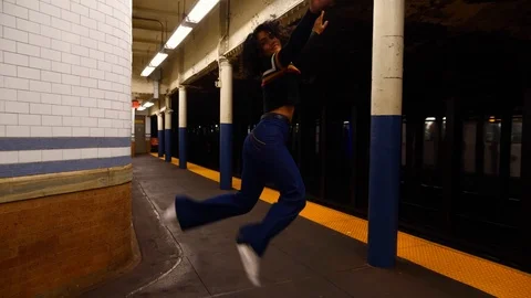 Happy young multi-ethnic hispanic female girl dancing in New York City subway Video stock 122533137