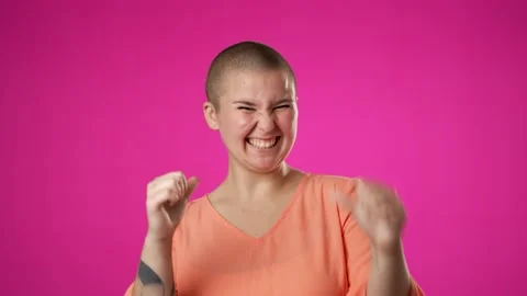 Happy young non binary gender fluid woman look at camera pointing fingers Stock Footage 223698462