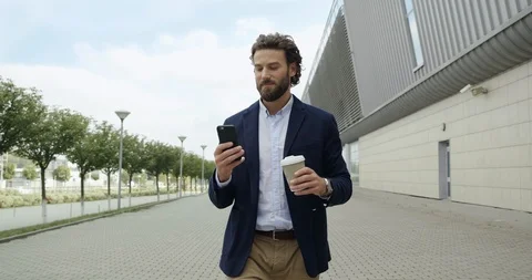 Happy young Office Worker is walking while the break and drinks some Coffee Stock Footage 117689232