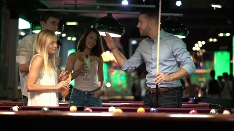Happy young people playing billard Stock Footage