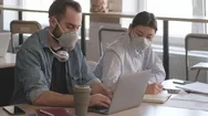 Happy Young People Wearing Masks Talking To Each Other While Working In Office Stock Footage