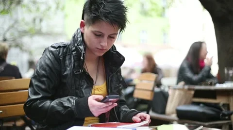 Happy young punk girl using smartphone in bar, steadicam shot HD Stock Footage