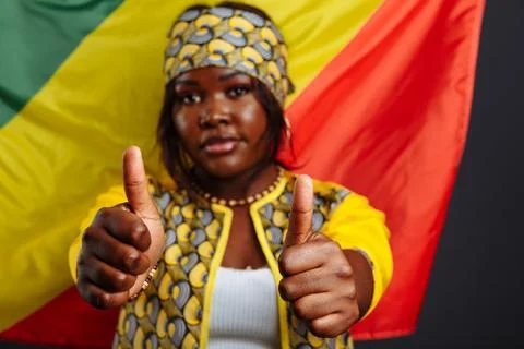 Happy Young Smiling African Woman with the flag of Congo republic on background Stock Photos