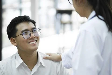 A happy young is smiling while his doctor is support him Stock Photos
