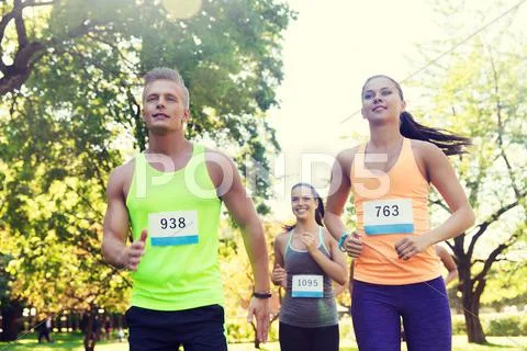 Happy young sportsmen racing wit badge numbers Stock Photos