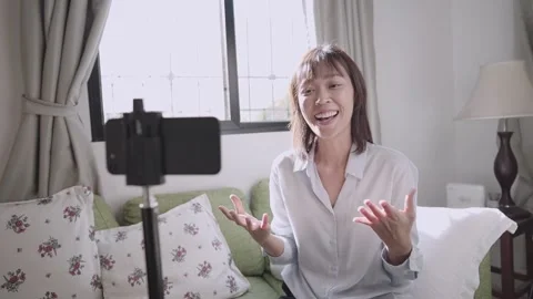 Happy young teacher talks to web camera making home distance online class video Stock Footage 144050924
