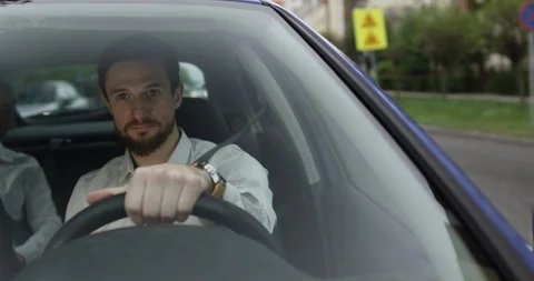Happy young uber driver in car with passenger on backseat Stock Footage 109560244