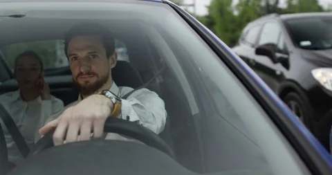 Happy young uber driver in car with passenger on backseat Stock Footage 110046798