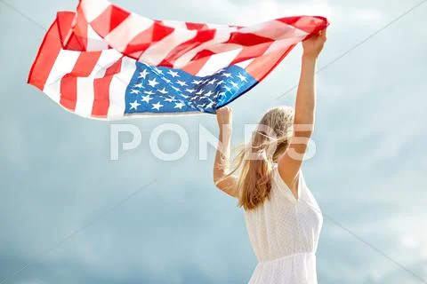 Happy young woman with american flag outdoors Stock Photos