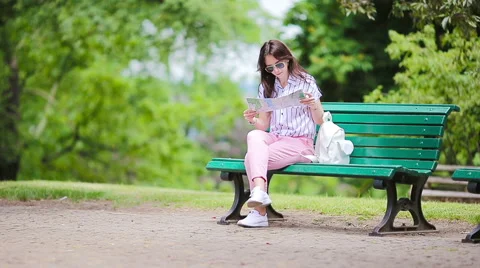 Happy young woman with a city map in Europe. Travel tourist woman with map in Stock Footage