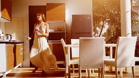Happy young woman dancing while cooking in the kitchen at home. slow motion Stock-Footage 101957608