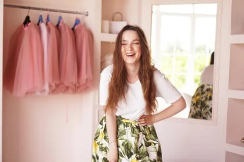 Happy young woman dressing up. Dressing room in pink Stock Photos