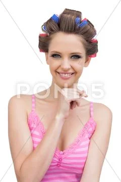 Happy young woman with hair curlers Stock Photos