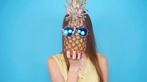 Happy young woman holding a pineapple Stock Footage