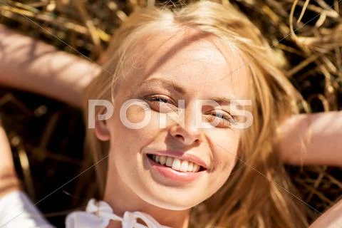 Happy young woman lying on cereal field Stock Photos