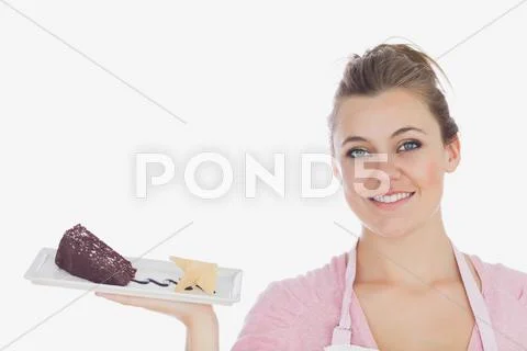 Happy young woman with plate of pastry Stock Photos