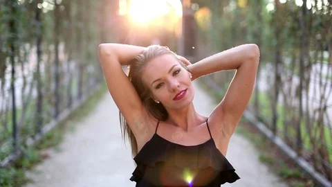 Happy young woman posing in sunset outdoors Stock Footage 122902018