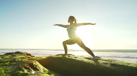 Happy young woman practicing yoga on the beach at sunset. Healthy active life Stock Footage 62011763