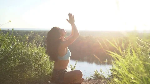 Happy young woman practicing yoga at sunset. Healthy active lifestyle concept Stock Footage 78652271