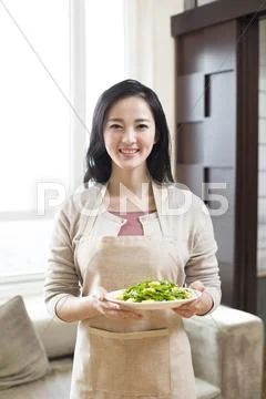 Happy Young Woman Serving Food