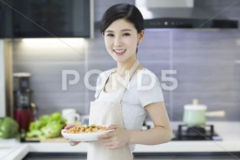 Happy Young Woman Serving Food
