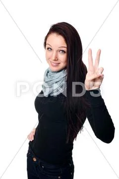 Happy young woman showing a success sign over white background Stock Photos