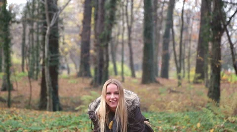 Happy young woman smiling and throwing leaves in the air Stock Footage 59553862