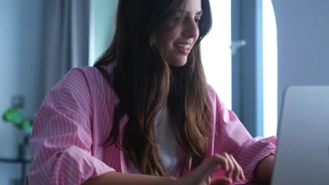 Happy Young Woman Smiling While Working on Laptop Stockbeeldmateriaal 333200775