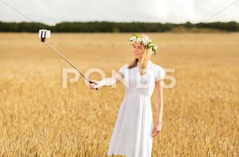 Happy young woman taking selfie by smartphone Stock Photos