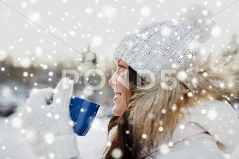 Happy young woman with tea cup outdoors in winter Stock Photos