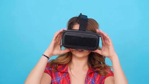 Happy young woman using a virtual reality headset Stock Footage 77548713
