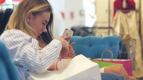 Happy young women looking into shopping bags Stock Footage