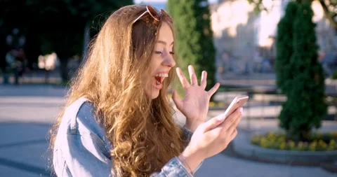 Happy young womman does videochat with friend on her smartphone. Stock Footage 123705624