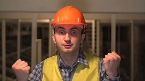 Happy young worker or an engineer or architect, man celebrating his success on Vidéo 89085610