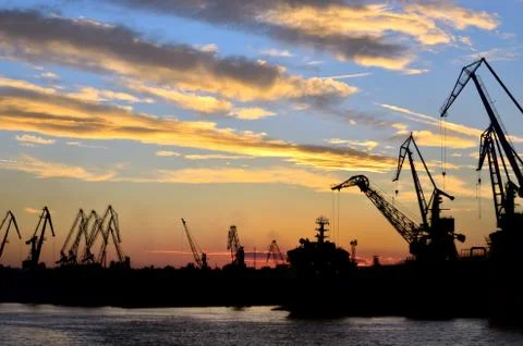 Harbor against red sunset background Stock Photos