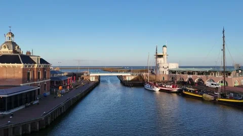 Harbor basin glide past old control building and moored craft Stock Footage 331843387