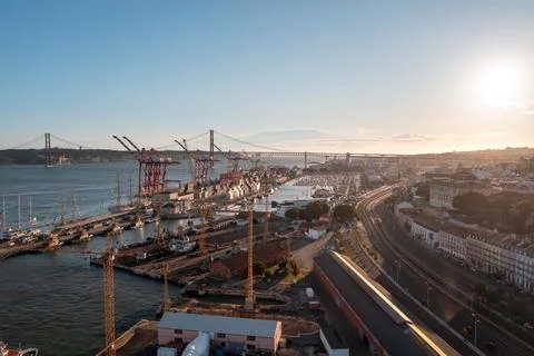 Harbor with bridge under cloudy sky, overlooking urban landscape by water 스톡 사진
