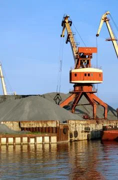 Harbor crane in operation. 2 Stock Photos
