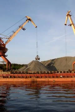 Harbor crane in operation. Stock Photos