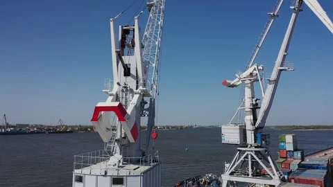 Harbor cranes lifting cargo containers over water 스톡 동영상 347518515
