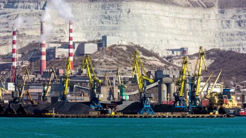 Harbor Cranes Loading Coal Next to a Quarry Stock Footage 147378652