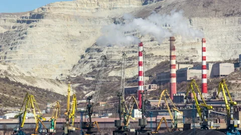 Harbor Cranes Loading Coal Next to a Quarry Stock Footage 147378726