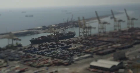 At the harbor a freighter is loaded. Tilt Shift on the freighter Stock Footage 99959633