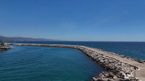 Harbor lighthouse beacon tower waterfront marina Marbella aerial view 動画素材 336449333