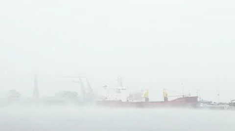 Harbor in mist unloading ship and moving cranes part 4 動画素材 9650564